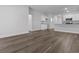 Bright living room with hardwood floors, and view leading into kitchen at 293 Sandridgebury Dr. # 66, Little River, SC 29566