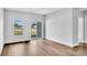 Bright living room features wood-look flooring, and sliding glass doors leading to the yard at 293 Sandridgebury Dr. # 66, Little River, SC 29566