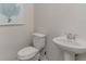 Small powder room with pedestal sink and toilet at 1052 Black Lake Way, Conway, SC 29526