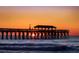 Sunrise over the ocean with a pier in silhouette at 660 Cardinal Ave. # 660, Myrtle Beach, SC 29577