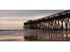 Long pier extending into the ocean at sunrise at 660 Cardinal Ave. # 660, Myrtle Beach, SC 29577