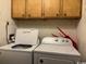Functional laundry area with a washer, dryer, and overhead storage cabinets at 212 2Nd Ave. N # 362, North Myrtle Beach, SC 29582