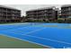 Bright blue community tennis court for residents, located near condo buildings at 212 2Nd Ave. N # 362, North Myrtle Beach, SC 29582