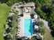 Aerial view of community pool area with chairs, umbrellas and tropical landscaping at 1521 James Island Dr., North Myrtle Beach, SC 29582