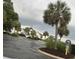 Community clubhouse and pool area featuring palm trees, lush landscaping, and ample parking at 1521 James Island Dr., North Myrtle Beach, SC 29582
