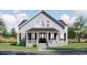 Charming two-story home featuring symmetrical windows, a covered porch, and a well-manicured lawn at 1521 James Island Dr., North Myrtle Beach, SC 29582