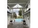 Community pool area featuring palm trees, cabana, lounge chairs and shade, and trash cans at 1521 James Island Dr., North Myrtle Beach, SC 29582