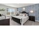 Spacious bedroom with a large bed, accent wall, and plenty of natural light at 4516 East Coast Ln., Shallotte, NC 28470