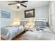 Cozy bedroom featuring two beds, a ceiling fan, and matching nightstands, offering a relaxing retreat at 1500 Cenith Dr. # F103, North Myrtle Beach, SC 29582