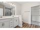 Bright bathroom features a double vanity with a quartz countertop and a large mirror at 623 Carter Reid Ct., Longs, SC 29568