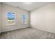 Bright bedroom with carpet floors and two windows providing natural light and scenic views at 623 Carter Reid Ct., Longs, SC 29568