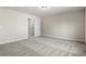 A well-lit carpeted bedroom features neutral walls, white trim, and closet with a white door at 623 Carter Reid Ct., Longs, SC 29568