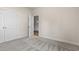 Bedroom with plush carpeting features a door and a window offering natural light at 623 Carter Reid Ct., Longs, SC 29568