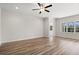 Bright, empty bedroom with hardwood flooring, white trim, ceiling fan and a view of the outdoors at 623 Carter Reid Ct., Longs, SC 29568