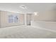 Spacious carpeted bonus room filled with lots of natural light from a large window at 623 Carter Reid Ct., Longs, SC 29568