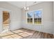 Bright dining room featuring wainscoting, stylish light fixture, and wood-look floors at 623 Carter Reid Ct., Longs, SC 29568