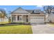 Charming home featuring a well-manicured lawn, two-car garage, and a welcoming front porch at 623 Carter Reid Ct., Longs, SC 29568