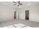 Spacious main bedroom with tray ceiling, ceiling fan, plush carpet and two doorways at 623 Carter Reid Ct., Longs, SC 29568