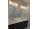 Double vanity bathroom with dark cabinets and a shower at 2104 Ballast Ct., Myrtle Beach, SC 29579