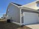 Gray house with white garage door and AC unit at 2104 Ballast Ct., Myrtle Beach, SC 29579