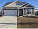 Gray house with white garage door and landscaping at 2104 Ballast Ct., Myrtle Beach, SC 29579