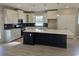 Spacious kitchen featuring white cabinets, quartz countertops, and dark island at 2104 Ballast Ct., Myrtle Beach, SC 29579