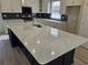 Modern kitchen island with white quartz countertop and dark lower cabinets at 2104 Ballast Ct., Myrtle Beach, SC 29579