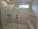 Large walk-in shower with marble tile and built-in seat at 2104 Ballast Ct., Myrtle Beach, SC 29579