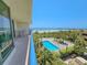 Balcony view of the beach, pool, and lush tropical landscaping at 8560 Queensway Blvd. # 104, Myrtle Beach, SC 29572