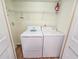 Laundry room area featuring a white washer, dryer, and wire shelf at 8560 Queensway Blvd. # 104, Myrtle Beach, SC 29572