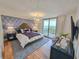 Bedroom with a king bed, balcony access, and stylish furnishings at 8560 Queensway Blvd. # 104, Myrtle Beach, SC 29572