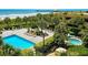 Overhead shot of the pool area, deck chairs, ocean, and palm trees at 8560 Queensway Blvd. # 104, Myrtle Beach, SC 29572