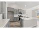 Modern kitchen with gray cabinets, white countertops, and an island at 1127 Cypress Shoal Dr., Conway, SC 29526