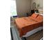 Well-lit bedroom featuring warm tones, a plush bed with orange bedding and a calming atmosphere at 2276 Essex Dr. # A, Myrtle Beach, SC 29575