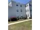 Exterior condo view featuring lush grass, shrubs, and a sidewalk at 2276 Essex Dr. # A, Myrtle Beach, SC 29575