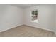 Cozy bedroom with neutral carpet, a window, and electrical outlets on the walls at 204 Cambridge Dr., Tabor City, NC 28463