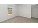 Bright bedroom with neutral carpet, a window overlooking the neighborhood, and a closet at 204 Cambridge Dr., Tabor City, NC 28463