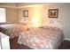 Bright bedroom with two beds, framed artwork, and a neutral color palette at 501 S Ocean Blvd. # 1104, North Myrtle Beach, SC 29582