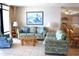 Inviting living room featuring cozy seating, a mirrored wall, and an open-concept layout at 501 S Ocean Blvd. # 1104, North Myrtle Beach, SC 29582