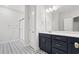 Bathroom with double vanity, a shower, and patterned tile flooring at 4414 Kinlaw St., Little River, SC 29566