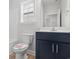 Clean bathroom, featuring a dark vanity and white toilet at 4414 Kinlaw St., Little River, SC 29566