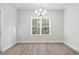 Bright dining room with hardwood floors, chandelier, and large window at 4414 Kinlaw St., Little River, SC 29566