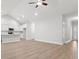 Open floor plan living room with hardwood floors, kitchen island, and access to other rooms at 4414 Kinlaw St., Little River, SC 29566