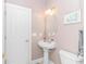 Bathroom with pedestal sink, framed art, and a white door at 5303 Pheasant Dr., North Myrtle Beach, SC 29582