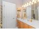 Well-lit bathroom featuring a vanity with decorative fixtures and a mirror at 5303 Pheasant Dr., North Myrtle Beach, SC 29582