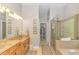 Well-lit bathroom with double vanity, walk-in shower, and soaking tub at 5303 Pheasant Dr., North Myrtle Beach, SC 29582