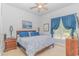 A bedroom with a bright window and patterned blue bedding at 5303 Pheasant Dr., North Myrtle Beach, SC 29582