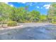 Gated entrance to a property with a paved driveway and lush landscaping at 5303 Pheasant Dr., North Myrtle Beach, SC 29582
