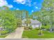 Charming single-story home with mature landscaping, a well-manicured lawn, and a long driveway at 5303 Pheasant Dr., North Myrtle Beach, SC 29582