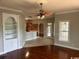 Open-concept living area with hardwood floors, neutral walls, ceiling fan and access to the kitchen and patio at 5303 Pheasant Dr., North Myrtle Beach, SC 29582